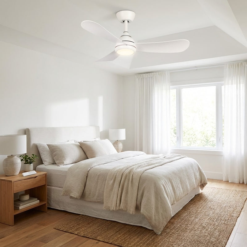 Modern bedroom with a ceiling fan, bed, and side table.